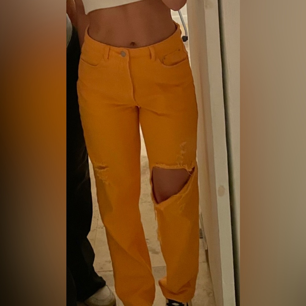 Orange jeans bought at a boutique.